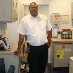 Charles Curry (Care Van Driver) poses for a photo in the van's greeting area.