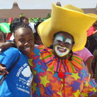 Student volunteer poses Miss Jane the Clown.